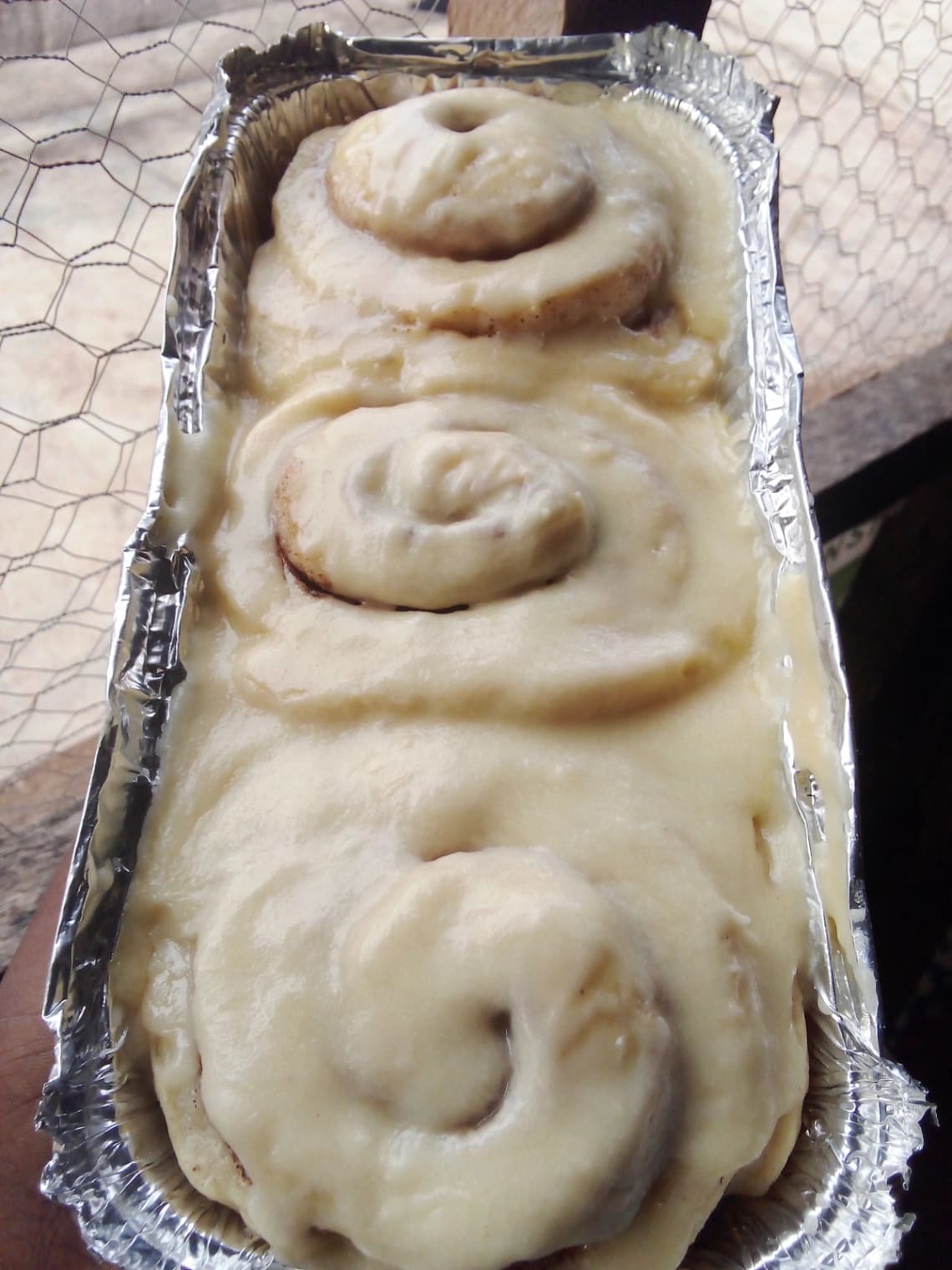 A pack of 3 cinnamon rolls with cream